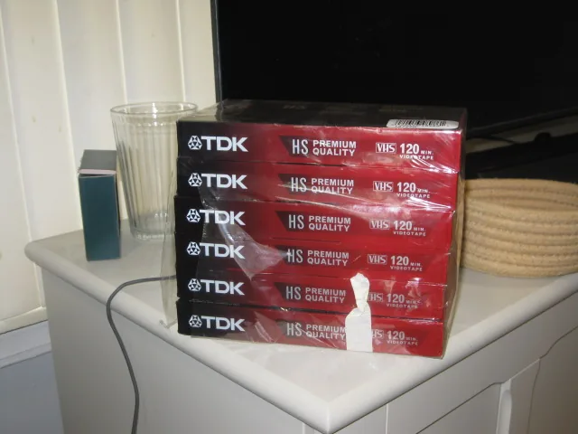 A stack of TDK VHS tapes waiting to be sorted
