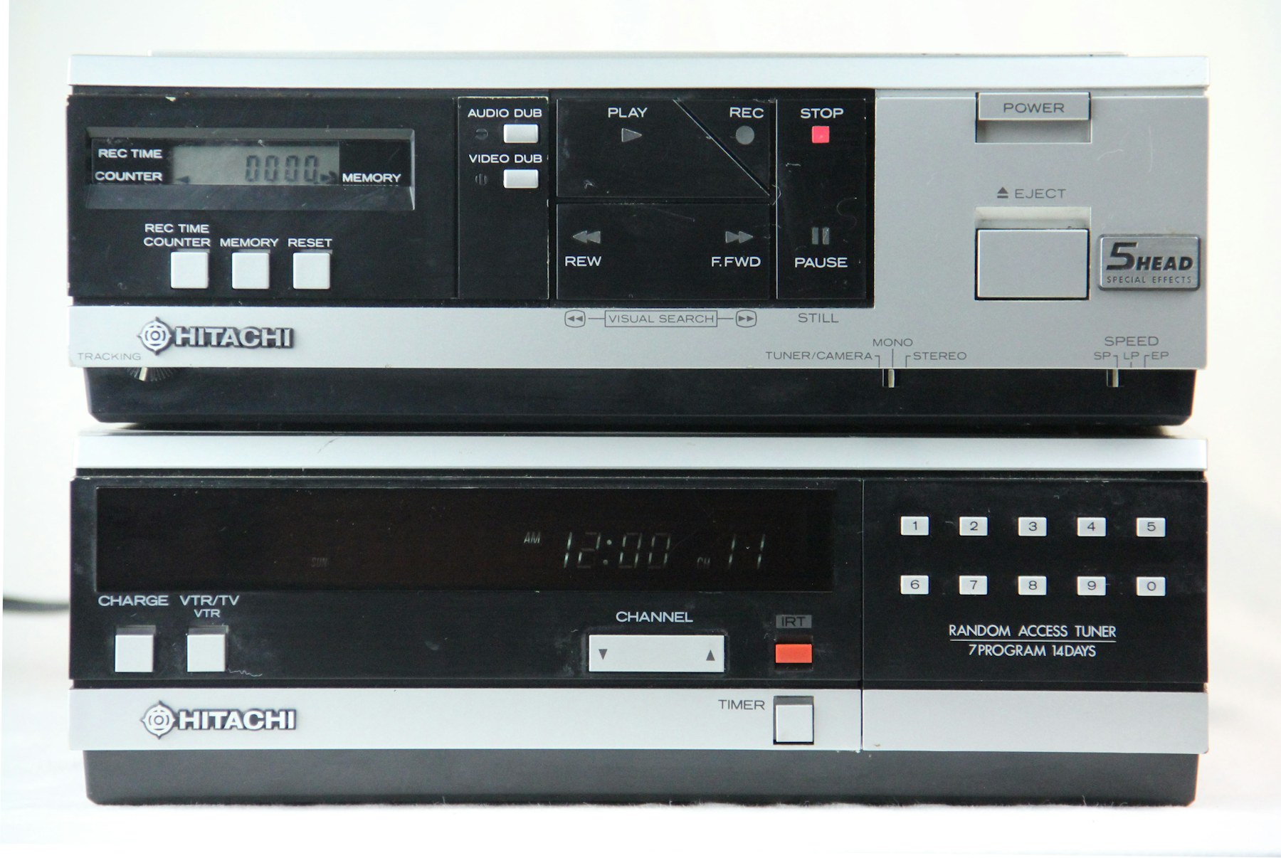 A black and grey vintage VCR player with front-panel controls and display.